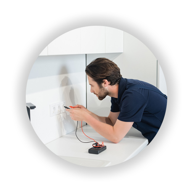 Electrician testing sockets in Kitchen