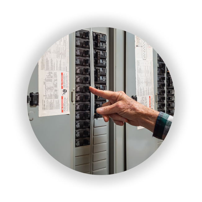 Electrician pointing at breaker panel