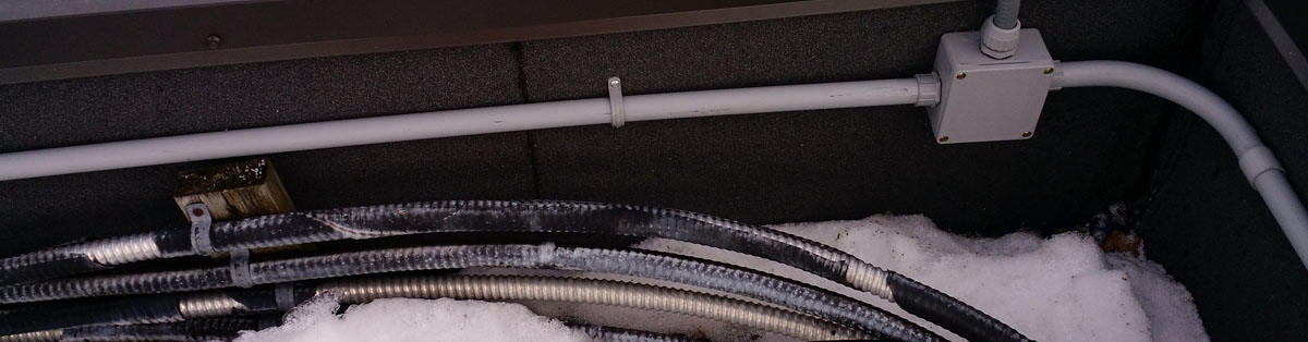 Exterior Wires and PVC Pipes leading to an electrical receptacle